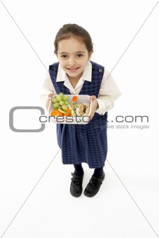 Studio Portrait of Smiling Girl Holding Lunchbox