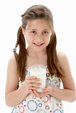 Studio Portrait of Smiling Girl Holding Glass of Milk