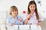 Siblings Brushing Teeth Together at Sink