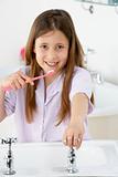 Young Girl Brushing Teeth at Sink