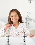 Young Girl Brushing Teeth at Sink
