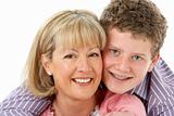 Studio Portrait of Smiling Teenage Boy with Mum