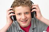 Portrait of Smiling Teenage Boy Listening to Music