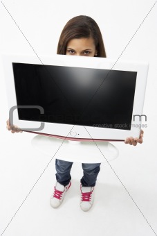 Portrait of Smiling Teenage Girl Holding Television