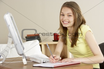 Smiling Teenage Girl Studying at Home