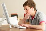 Teenage Boy in Thought Studying at Home