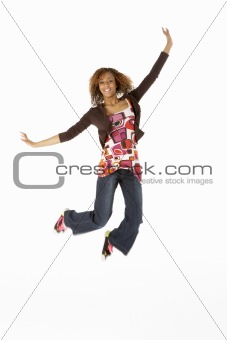 Full Length Studio Portrait Of Jumping Teenage Girl