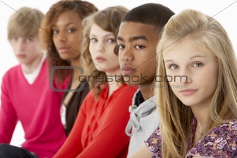 Studio Portrait Of Five Teenage Friends Standing In Line