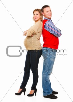 Full length portrait of happy beautiful pregnant woman with husband on white background 
