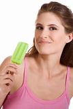 Young woman eating green frozen sorbet on stick