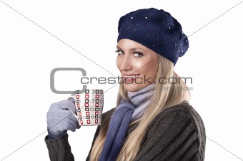 winter fashion girl holding a hot cup of tea