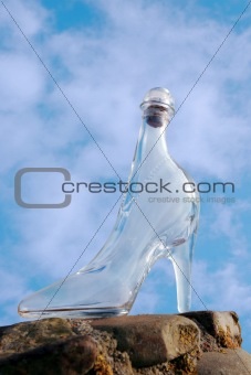 glass high heel shoe on rocky surface