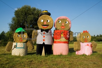 Four figures made out of straw bales