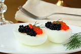 Boiled eggs with red and black caviar