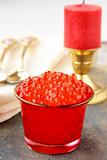 Fresh red caviar in a glass jar