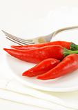 hot chili peppers on white plate