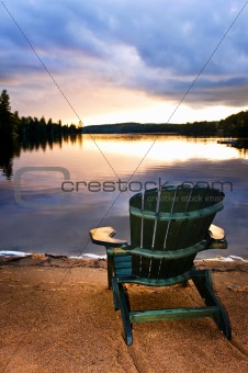 Wooden chair at sunset on beach