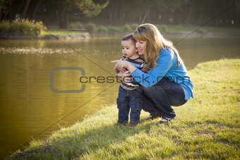 Happy Mother and Baby Son Looking Out At The Pretty Lake.