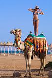 Woman Standing on a Camel