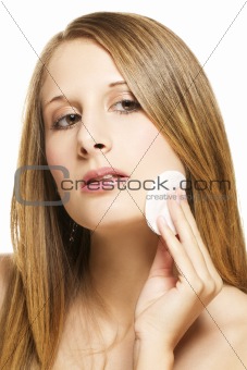 young woman removing makeup