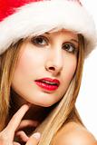 closeup of a glamorous woman wearing santas hat
