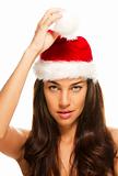 young beautiful woman holding tip of santas hat