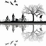 Family cycling on the edge of the lake