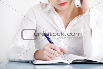Closeup on woman`s writing hand.
