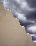 Adobe Wall With Storm Clouds