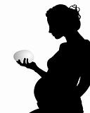 silhouette of a pregnant woman with an egg