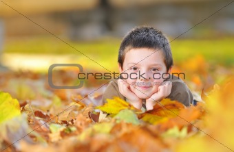 kid playing with leaves