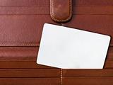 White business card in leather bag