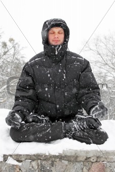 man meditating in winter