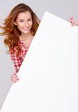 Young woman in casual clothing holding empty board