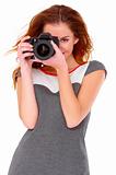 Woman in gray dress wit digtal camera on white