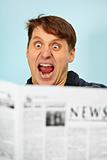 Man shocked - bad news from newspaper