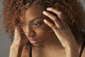 Studio Portrait Of Stressed Teenage Girl