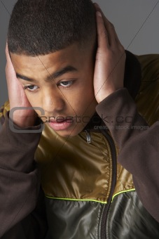 Teenage Boy Covering Ears With Hands