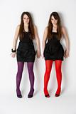 Studio Portrait Of Fashionably Dressed Twin Teenage Girls