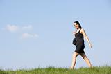Woman Walking Through Summer Countryside