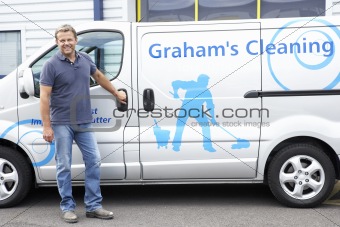 Cleaner standing next to van