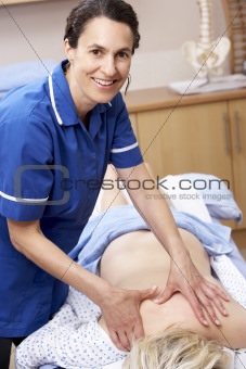 Osteopath treating female client