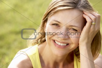 Portrait of young woman relaxing in countryside