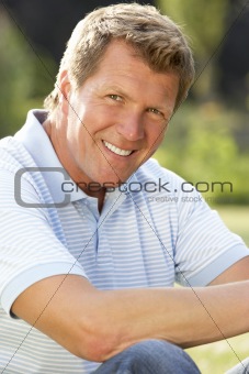 Portrait of young man relaxing in countryside