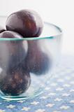 Glass bowl with plums