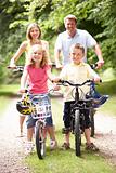 Family riding bikes in countryside