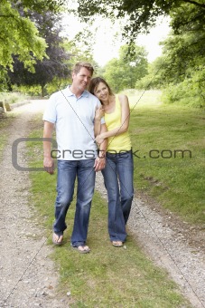 Middle aged couple walking in countryside