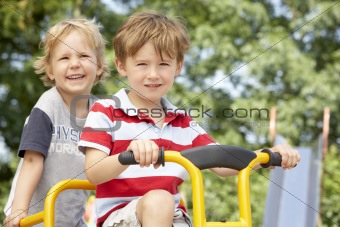 Two Young Boys Playing on Bike