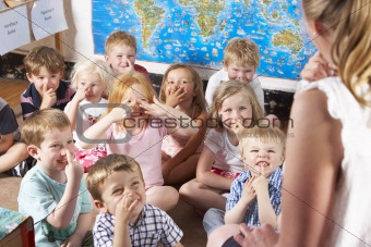 Montessori/Pre-School Class Listening to Teacher on Carpet