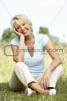Portrait of mature woman sitting in countryside